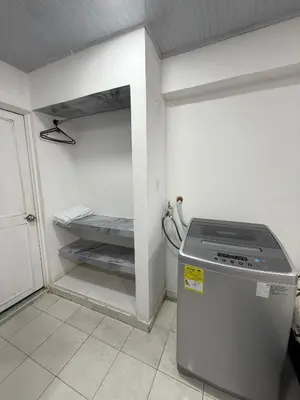 a small kitchen with a refrigerator in a room at Hermoso estudio en Cartagena edificio frente al mar in Cartagena de Indias