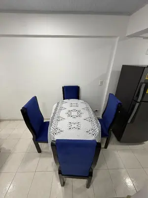 a table with two blue chairs and a table with at Hermoso estudio en Cartagena edificio frente al mar in Cartagena de Indias