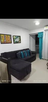 a living room with a brown couch and blue pillows at Apartamento turístico cerca al mar en Cartagena in Cartagena de Indias