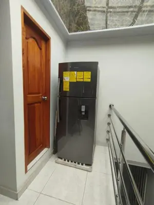a black refrigerator in a wall next to a door at Casa Turistica Parador Verona in Cartagena de Indias