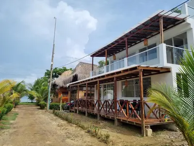 a house on the side of a dirt road at HELENA Beach House in La Rada