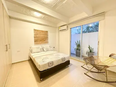 a bedroom with a bed and a large window at Apartment for 4 Guests in Sabanilla a few steps from the sea in Maizal