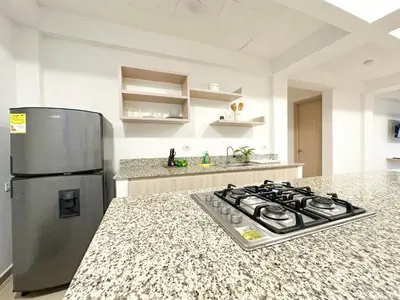a kitchen with a stove and a refrigerator at Apartment for 4 Guests in Sabanilla a few steps from the sea in Maizal