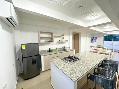 a kitchen with a refrigerator and a counter top at Apartment for 4 Guests in Sabanilla a few steps from the sea in Maizal