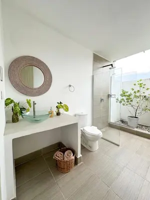 a bathroom with a sink and a toilet and a mirror at Apartment for 8 Guests in Sabanilla a few steps from the Sea in Maizal