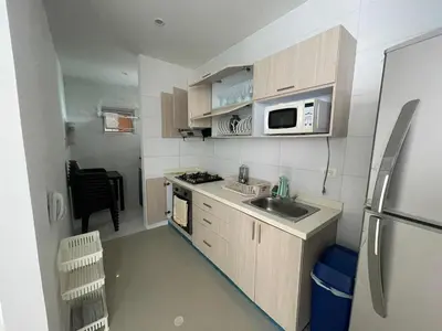 a small kitchen with a sink and a refrigerator at Apartamentos Mi Reserva OK - Arrecife in Coveñas