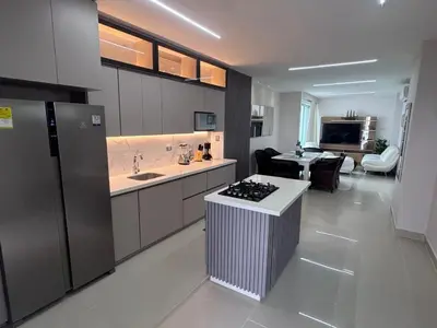 a kitchen with a refrigerator and a stove in it at Apartamentos Mi Reserva OK - Arrecife in Coveñas
