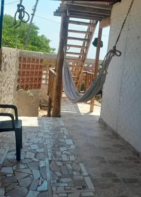 a hammock hanging from the side of a building at Cabaña Barbacoas1 in Santa Ana