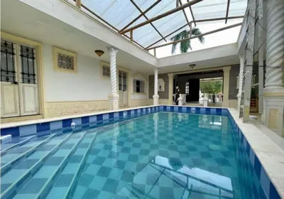 an indoor swimming pool with a glass roof at Quinta San Gabriel House in Turbaco
