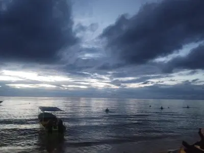 a group of people in the water on a beach at Los Clemones in Rincón