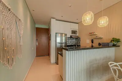 a kitchen with a counter and a refrigerator at Apartamento con vista al mar - Piscina en la azotea - 2 habitaciones + 2 baños in Cartagena de Indias