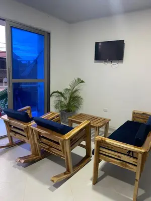 a room with three chairs and a television on a wall at Apartamento Salome in Coveñitas