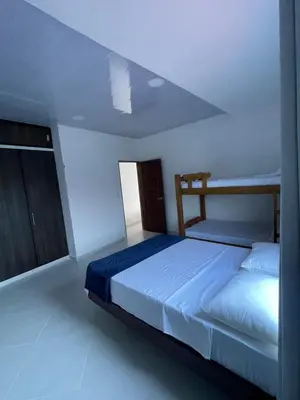 a bedroom with a bed in a white room at Apartamento Salome in Coveñitas