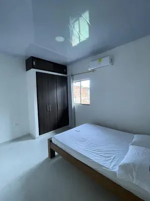 a white bedroom with a bed and a window at Apartamento Salome in Coveñitas