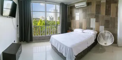 a bedroom with a bed and a large window at Cartagena Apartamento in Cartagena de Indias