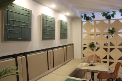 a waiting room with a table and green doors at Hotel Fontamar 72 in Barranquilla
