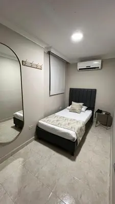 a bedroom with a bed and a mirror at Hotel Fontamar 72 in Barranquilla