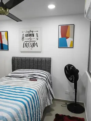 a bedroom with a bed and a poster on the wall at Espectacular apartamento amoblado en BARRANQUILLA in Barranquilla