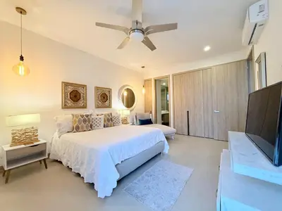a bedroom with a bed and a flat screen tv at Espectacular apartamento con piscina privada - Morros Zoe in Cartagena de Indias
