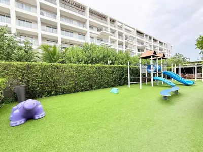 a playground in front of a large building at Espectacular apartamento con piscina privada - Morros Zoe in Cartagena de Indias