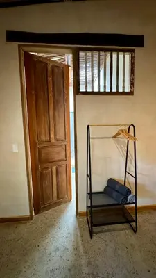 a room with a chair in front of a door at Casa del Tunel Lodge in Getsemani in Cartagena de Indias
