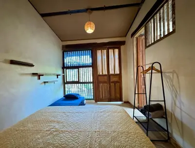 a bedroom with a bed and a ladder in a room at Casa del Tunel Lodge in Getsemani in Cartagena de Indias