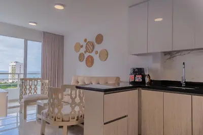 a kitchen with a counter and some chairs in a room at Cartagena Económica con Estilo y Comodidad in Cartagena de Indias