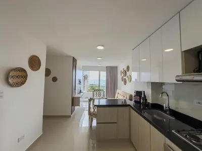 a kitchen with white cabinets and a counter top at Cartagena Económica con Estilo y Comodidad in Cartagena de Indias