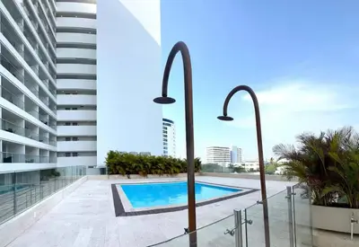 a swimming pool on the roof of a building at Ocean View ApartaSuite 16th Floor in Cartagena de Indias