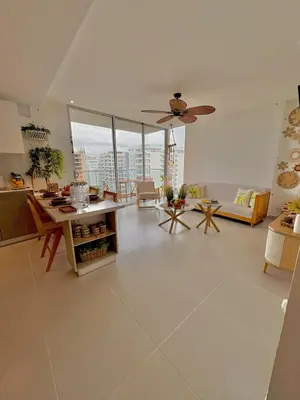 a large living room with a ceiling fan at Sea view with private balcony in Cartagena de Indias