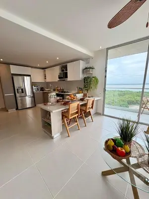 a kitchen with a table and chairs and a large window at Sea view with private balcony in Cartagena de Indias