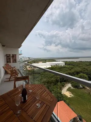 a balcony with a wooden table and a view of the ocean at Sea view with private balcony in Cartagena de Indias