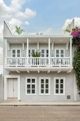 a white house with a balcony on top of it at Hotel Casa Sonara in Cartagena de Indias