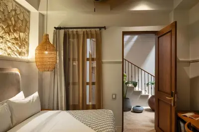 a bedroom with a bed and a sliding glass door at Hotel Casa Sonara in Cartagena de Indias