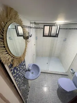 a bathroom with a sink and a mirror and a toilet at Apartment near the beach and airport in Cartagena de Indias