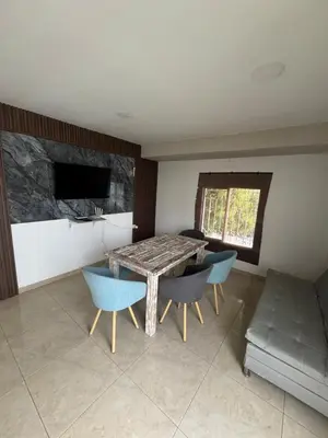 a dining room with a table and blue chairs at Apartment near the beach and airport in Cartagena de Indias