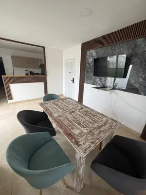 a dining room with a table and chairs and a television at Apartment near the beach and airport in Cartagena de Indias