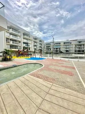 an apartment complex with a playground in a courtyard at Hermoso apartamento serena del mar #1 in Puerto Tierrabaja