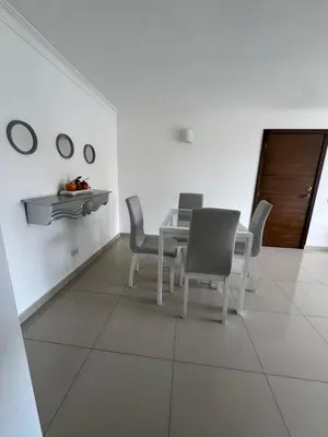 a white dining room with a table and chairs at Apartamento diagonal a bv norte in Barranquilla
