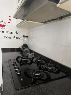 a kitchen with a stove top oven in a kitchen at Apartamento diagonal a bv norte in Barranquilla
