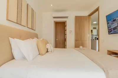 a bedroom with a large white bed with white pillows at BK2L | Escápate a Baía Kristal, sol + arena blanca in Los Arrayanes