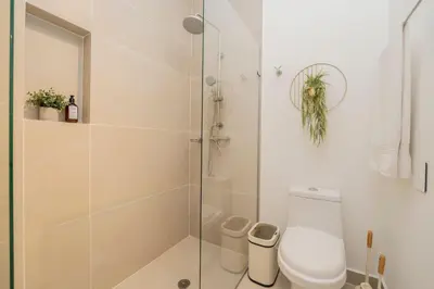 a bathroom with a toilet and a glass shower at BK2L | Escápate a Baía Kristal, sol + arena blanca in Los Arrayanes