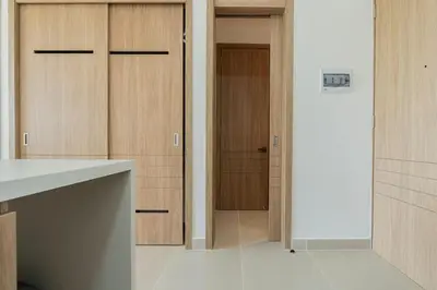 a kitchen with wooden cabinets and a white counter top at BK2L | Escápate a Baía Kristal, sol + arena blanca in Los Arrayanes
