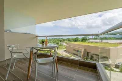 a dining room with a table and chairs and a large window at BK2L | Escápate a Baía Kristal, sol + arena blanca in Los Arrayanes