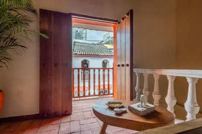 a room with a table and a view of a balcony at Casa D Boutique in Cartagena de Indias