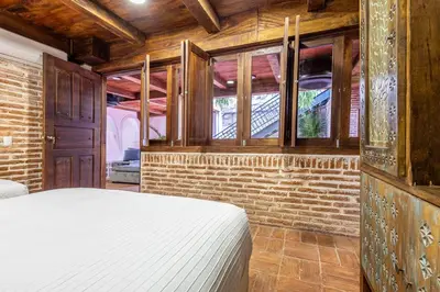a bedroom with a bed and a brick wall at Casa D Boutique in Cartagena de Indias