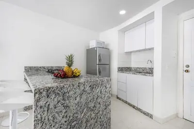 a kitchen with a counter with a bowl of fruit on it at Riviera Exclusive - Apartamento con vista al mar in Cartagena de Indias