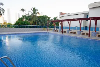 a large blue swimming pool in a building at Riviera Exclusive - Apartamento con vista al mar in Cartagena de Indias