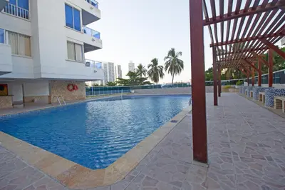a swimming pool in front of a building at Riviera Exclusive - Apartamento con vista al mar in Cartagena de Indias