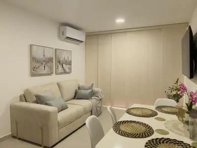 a living room with a couch and a table at 2 cuartos AC y piscina in Cartagena de Indias